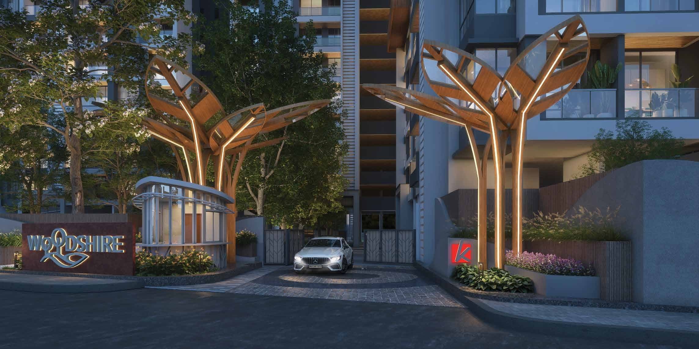 Kohinoor Woodshire, Bhugaon — grand entrance plaza with illuminated leaf canopies